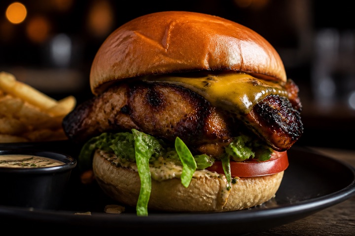 Burger: Jerk or curry chicken burger with lettuce, tomato, cheese, and jerk sauce.