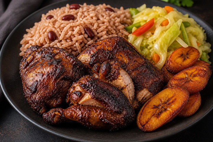 Jerk Chicken: Chicken jerked on the charcoal grill, sautéed with jerk sauce. Served with rice, cabbage and plantain.